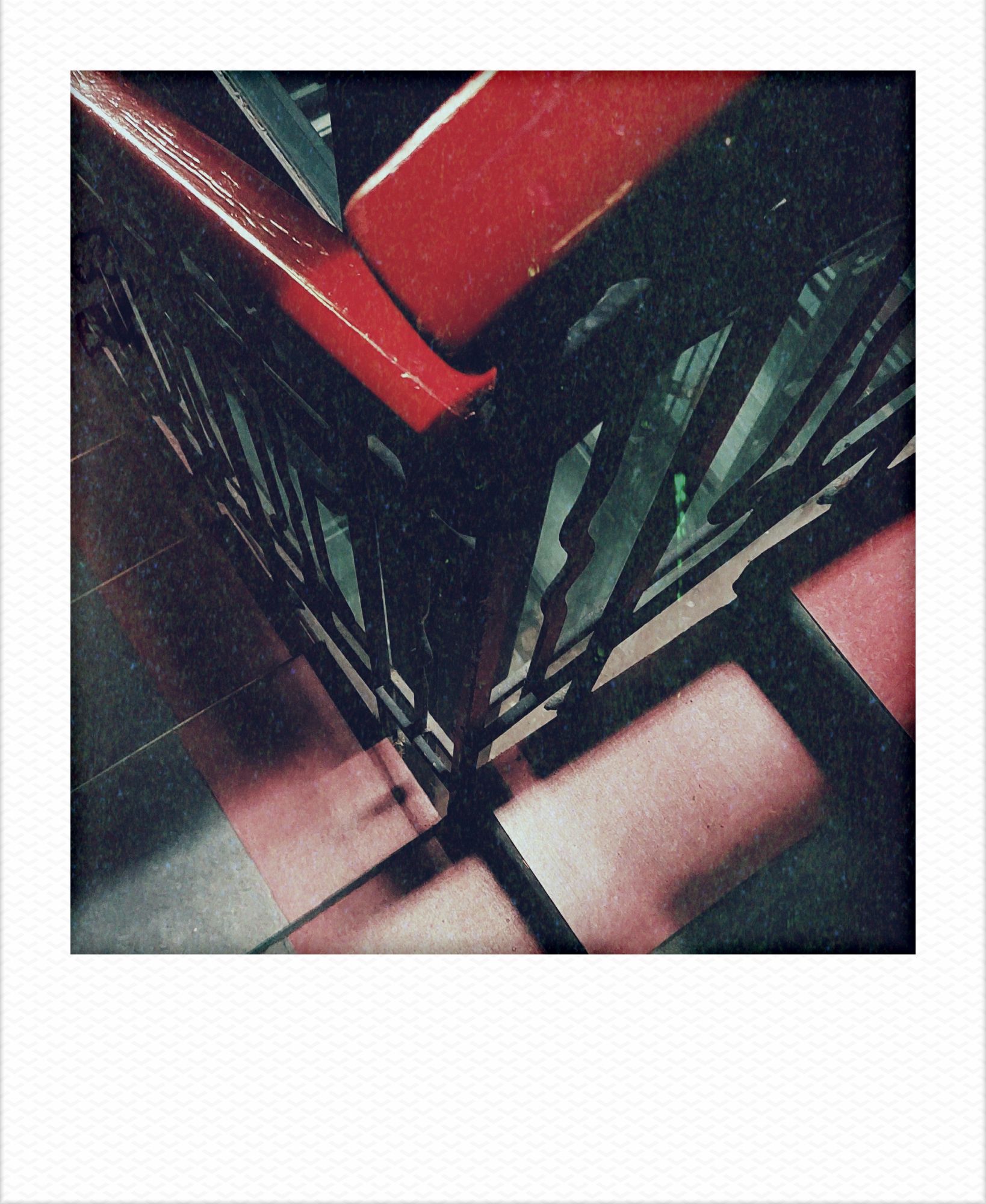 Staircase and a red wooden railing in twilight.