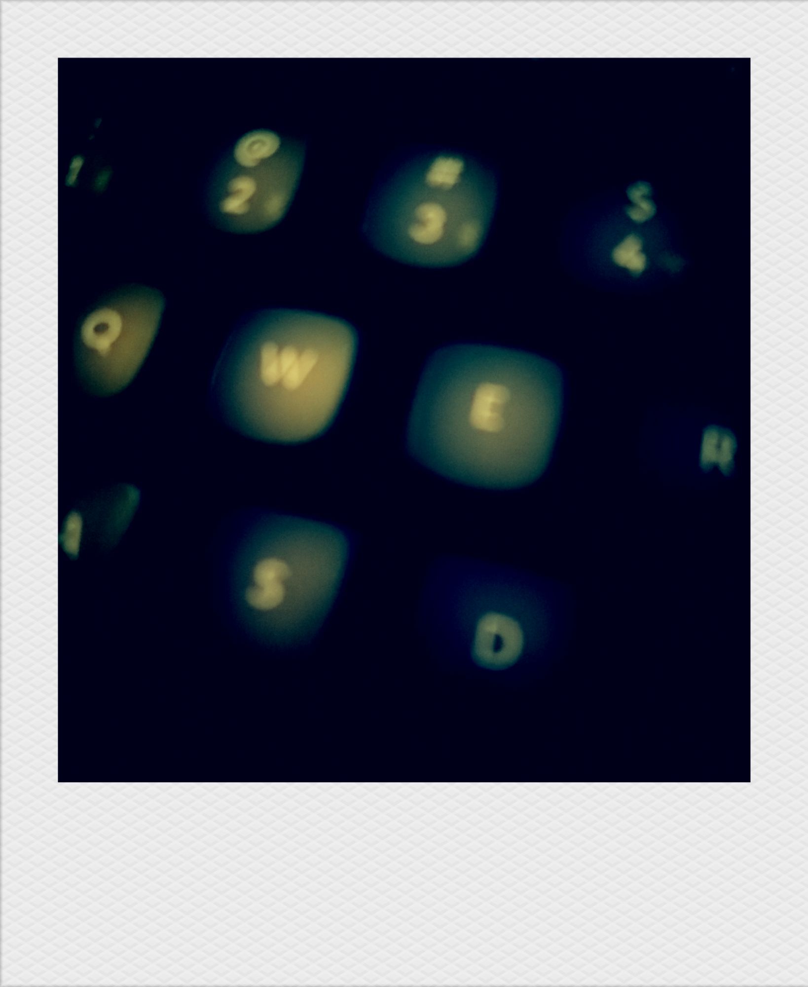 Parts of a computer keyboard, dimly lit