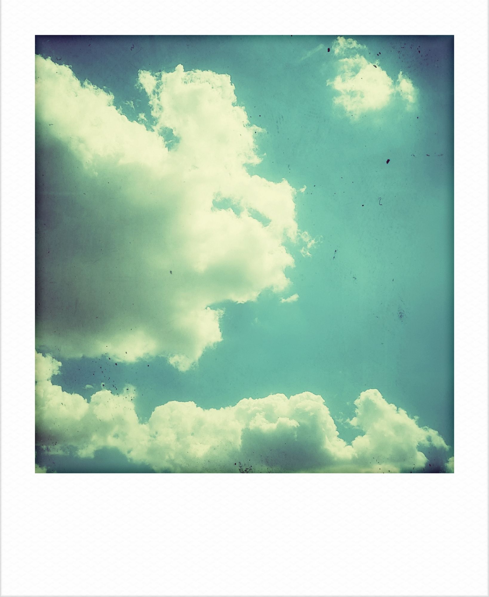 Clouds in a blue sky, vintage photography style.