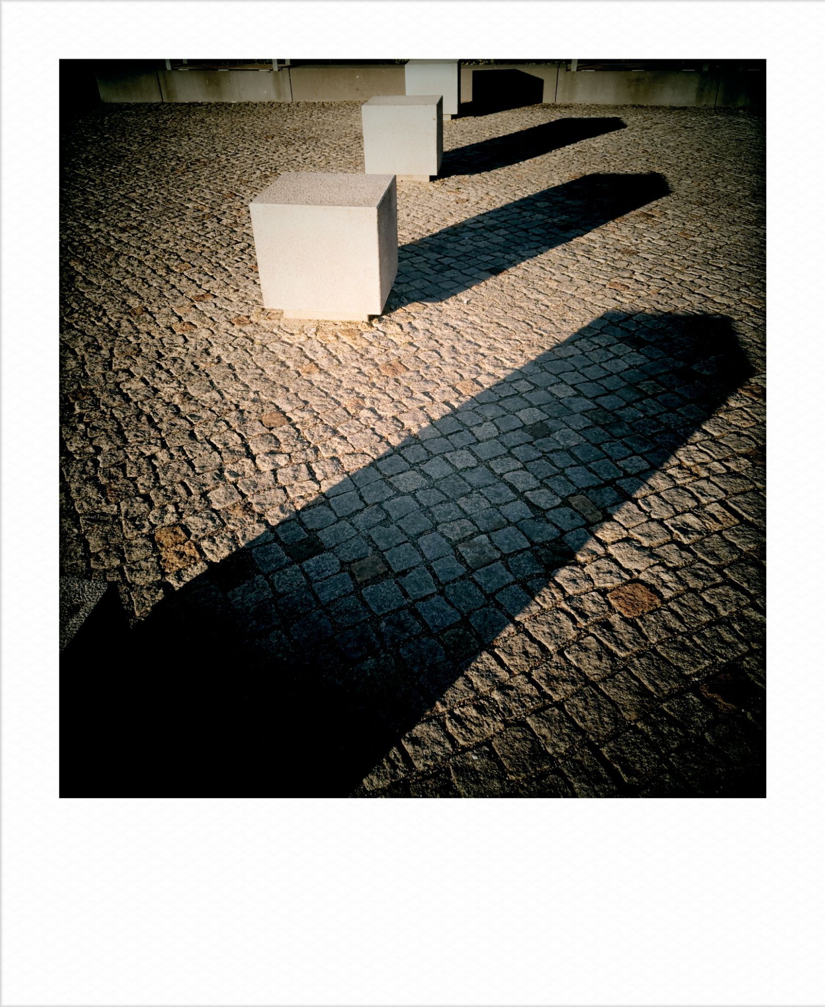 Concrete cubes casting early sun shadows.